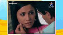 a picture of a man touching a woman 's face with a star india logo on the bottom