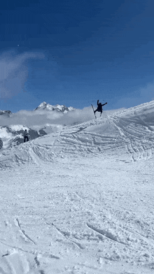 a person on skis is doing a trick on a snowy hill