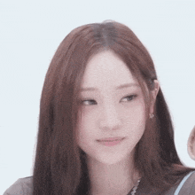 a close up of a woman with long hair and earrings