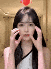 a woman with long black hair is making a funny face