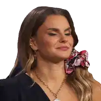 a woman wearing a necklace and earrings with a floral scarf around her ear