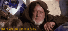 a man with a beard says there are no epstein files in front of a r2d2 robot