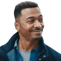 a man wearing a blue jacket and a blue shirt smiles