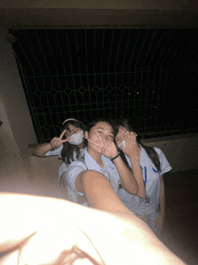 a girl wearing a name tag that says ' aa ' on it poses with two other girls