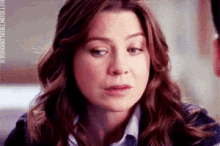 a close up of a woman 's face with a sad look on her face