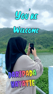 a woman taking a picture with the words you 're welcome and daripada hayatie