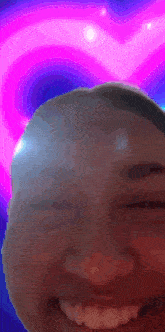 a close up of a person 's face with a pink heart in the background