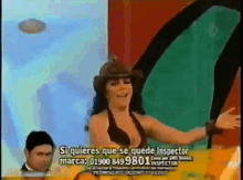 a woman in a cowboy hat is standing in front of a sign that says inspector