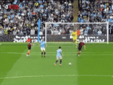 soccer players on a field with a sign that says ' bbva ' on it