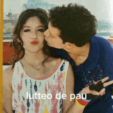 a man kissing a woman on the cheek with the words lutteo de pau below