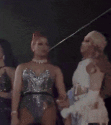 a blurry photo of three women standing next to each other with one wearing a mask