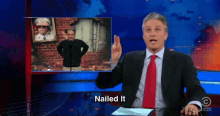 a man in a suit and tie says nailed it in front of a screen
