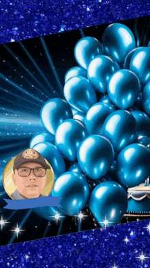 a man wearing glasses is surrounded by blue balloons and a speech bubble