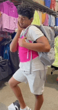 a man with a backpack talking on a cell phone