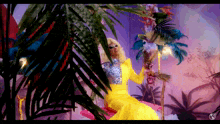 a woman in a yellow dress surrounded by palm trees