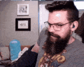 a man with a beard wearing glasses and a t-shirt that says " yo " on it