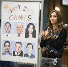 a woman stands in front of a jimmy jab games poster