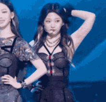 two women are standing next to each other on a stage .