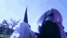 a person in a unicorn costume with a purple horn on their head