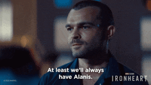 a man says " at least we 'll always have alanis " in front of a poster for ironheart