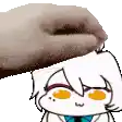 a hand is petting a cartoon character 's head with orange eyes .