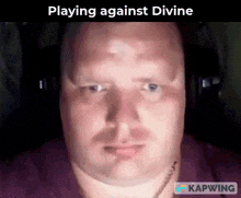 a bald man wearing headphones is playing against divine on kapwing