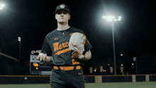 a baseball player wearing a black merc jersey