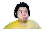 a man wearing headphones and a yellow shirt making a face