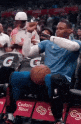 a man is sitting in a chair with a gatorade sign