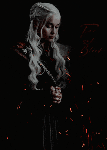a woman with long blonde hair is holding a sword and the words fire and blood are above her