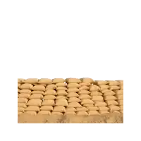 a man is holding a red uno card in front of sandbags