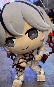 a stuffed doll is holding a sword and a rose in her hand .