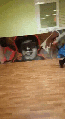 a painting of a man 's face is on a wall in a room