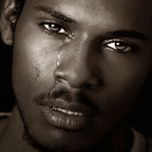 a man with a tear running down his face