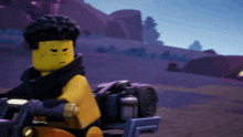 a lego figure is riding a motorcycle in a desert