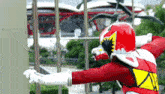 a man in a red superhero costume with the number 8 on his chest