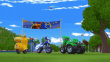 a yellow scooter and a green motorcycle are parked in front of a blue banner