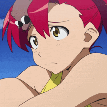 a close up of a girl with red hair and a cat on her head