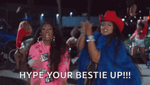 two women in cowboy hats are dancing in a video .