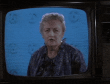 a person is standing in a dark room with a blue lightning bolt coming out of their body .