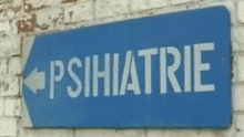 a blue sign on a brick wall says psihiatrie