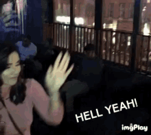 a woman waving her hand with the words hell yeah on the bottom right