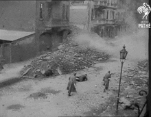 a black and white photo taken by pathe shows a pile of rubble on the street