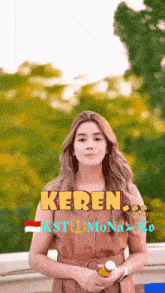 a woman is standing in front of trees and the word keren is on her chest