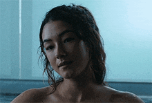 a woman without a shirt is sitting in a bathtub .