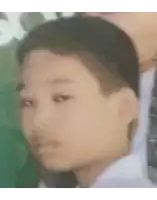 a blurry picture of a young boy 's face with a green background