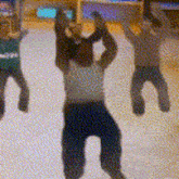 a group of people are standing on an ice rink with their arms in the air