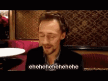 a man with his eyes closed is laughing and the words eh eh eh eh eh are visible