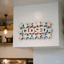 a sign on a wall that says closed with stars