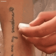 a person has a tattoo on their wrist that says ' i am my sunshine '
